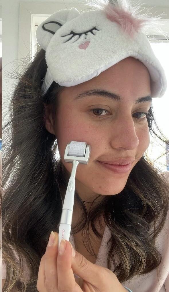 Girl Using a derma roller at home with skincare
